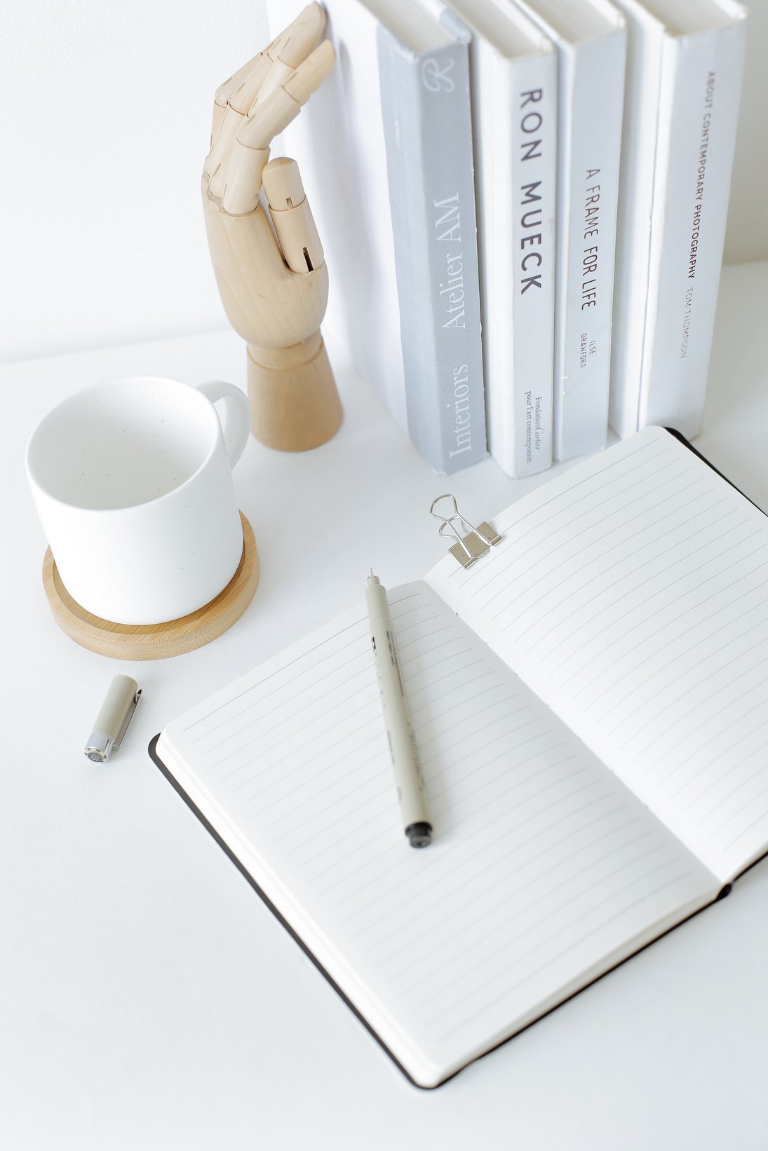 Notebook opened on desk near books